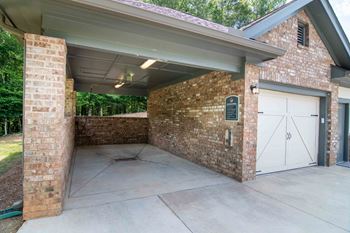 the garage of a house with white doors and a cement driveway at Century New Holland, Georgia